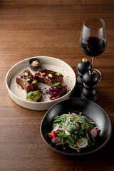 Vegetarian dinner with gourmet meals in a fancy restaurant, served on wooden table, top view