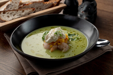 Seafood cream soup with crab meat and prawns in a fancy fish restaurant, soft light, appetizing food commercial, wooden background