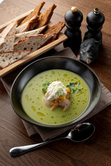 Top view of seafood cream soup with prawns in a fancy fish restaurant, appetizing food commercial, bread and spoon aside