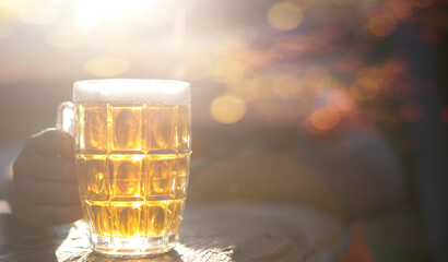 Close up a glass of beer on wood.