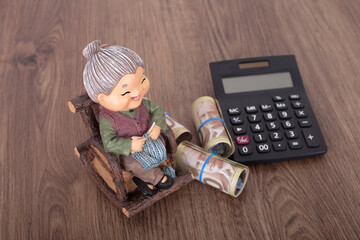 Granny model and calculator and Canadian dollar bills on the table