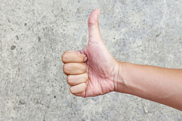 hand showing thumbs up, isolated on grey background