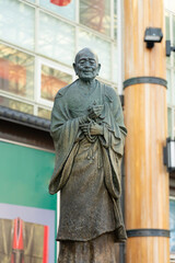 Fototapeta na wymiar A statue of Gyoki Bosatsu in front of the train station in Nara, Japan