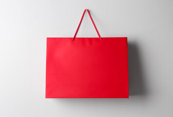 Paper shopping bag hanging on white wall