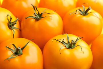 Many ripe yellow tomatoes as background, closeup