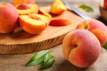 Naklejka na ściany i meble Fresh sweet peaches on wooden table, closeup