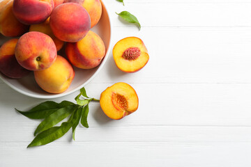 Fototapeta na wymiar Fresh sweet peaches on white wooden table, flat lay. Space for text