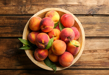 Fresh sweet peaches on wooden table, top view