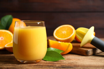 Glass of orange juice and fresh fruits on wooden table, closeup