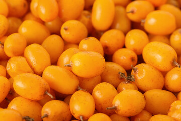 Ripe sea buckthorn berries as background, closeup