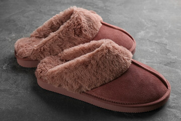 Fototapeta na wymiar Pair of stylish soft slippers on grey background