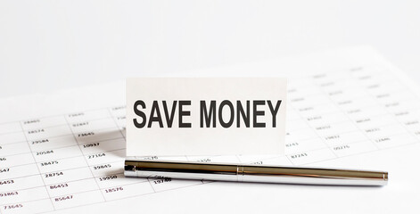 Fototapeta premium Text SAVE MONEY on stickers,pen on the background of documents. Financial bookkeeping, Accounting Concept. Top view.