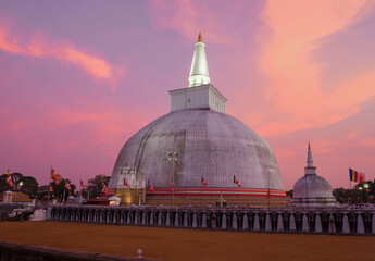 Ancient Dagoba Ruwanweli Maha Seya against the backdrop of a colorful sunset. Anuradhapura, Sri Lanka