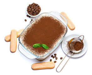 Traditional Italian Tiramisu dessert in glass baking dish and savoiardi cookies isolated on white