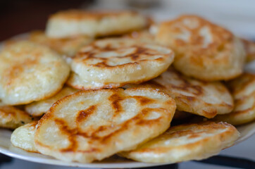 A serving of fried pancakes on a plate.