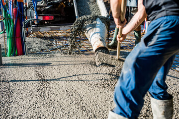 mixer truck pouring concrete on the construction site © Image'in