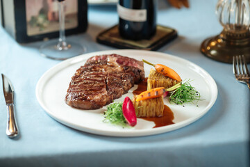 Grilled ribeye steak with potatoes with red wine