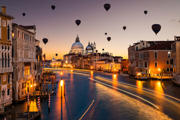 Hot air balloon over Grand Canal and Basilica Santa Maria della Salute at sunset, Venice, Italy