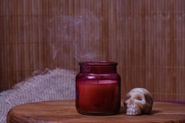 Smoke from an extinguished candle in a glass jar. Halloween concept