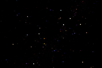 Stars on a dark night sky. Blurred, defocus. Abstract background