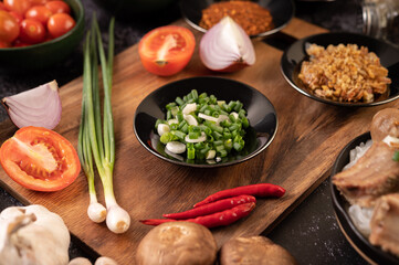 Chopped spring onion In the black plate.