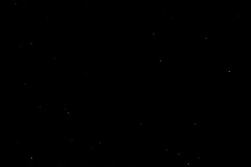 Stars on a dark night sky. Blurred, defocus. Abstract background