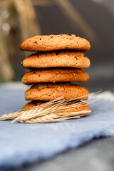Fresh oatmeal cookies on a dark background