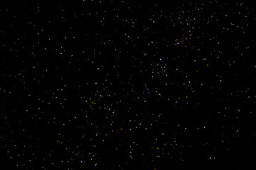 Stars on a dark night sky. Blurred, defocus. Abstract background