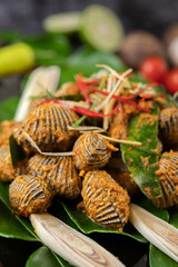 Cockles sauteed in curry powder with bell peppers and tomatoes.