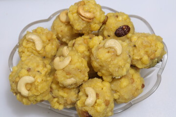 pile of indian sweet bundi laddu or motichur laddu stacked on white background