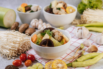 Chicken soup with corn, shiitake mushroom, enoki mushroom, and carrot.