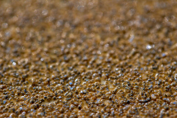 Full frame macro abstract background view of sand paper texture with stone grit