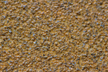 Full frame macro abstract background view of sand paper texture with stone grit
