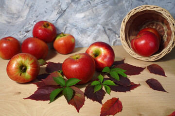 autumn still life with red apples and leaves