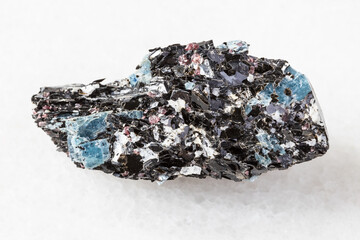 macro photography of sample of natural mineral from geological collection - unpolished Biotite rock with Kyanite crystals from Khit-ostrov deposit, Karelia, Russia on white marble background