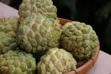 View a group of custard apple in basket, tropical fruits from Asia