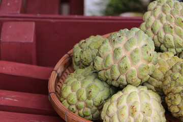 View a group of custard apple in basket, tropical fruits from Asia