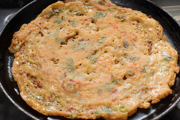 Traditional Southern Indian rice Dosa on white background.