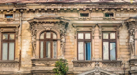 Detail with an old worn out building. Old vintage architecture in Bucharest, Romania.