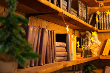 New Year or Christmas background, backdrop. Cozy bookshelf on christmas eve.