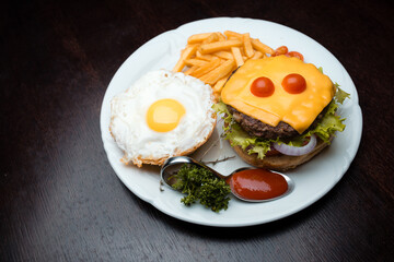Cheeseburger with egg and french fries 