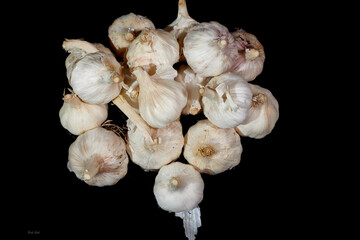 A bunch of garlic spread out on a tabletop.