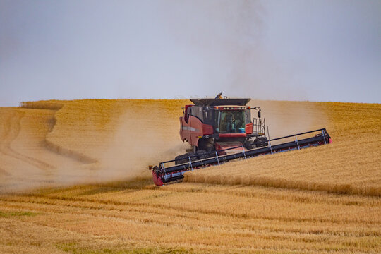 Combine harvester on the yellow hills. Plowed fields, an incredible drawing of the earth. Steptoe Butte State Park, Eastern Washington, in the northwest United States.