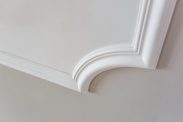 Detail of wall with intricate crown molding.