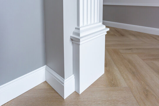 Detail of corner flooring with intricate crown molding.