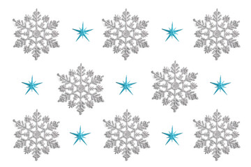 Fototapeta premium pattern of Christmas decor in the form of silver snowflakes on a white background. new year concept, top view