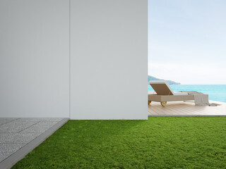 Lounge chair on terrace near swimming pool and garden in modern beach house or luxury villa. Wooden deck 3d rendering with sea view.