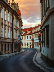 Fototapeta na wymiar Dramatic sunset on an empty historic street in Prague