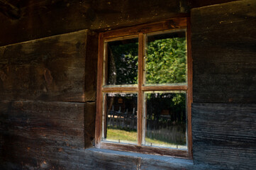 Window in the wall of an old wooden house