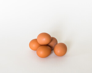 Brown eggs in the white background 